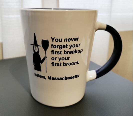 "You never forget your first breakup or your first broom" White, ceramic, 13oz coffee mug with cobalt blue handle and interior.